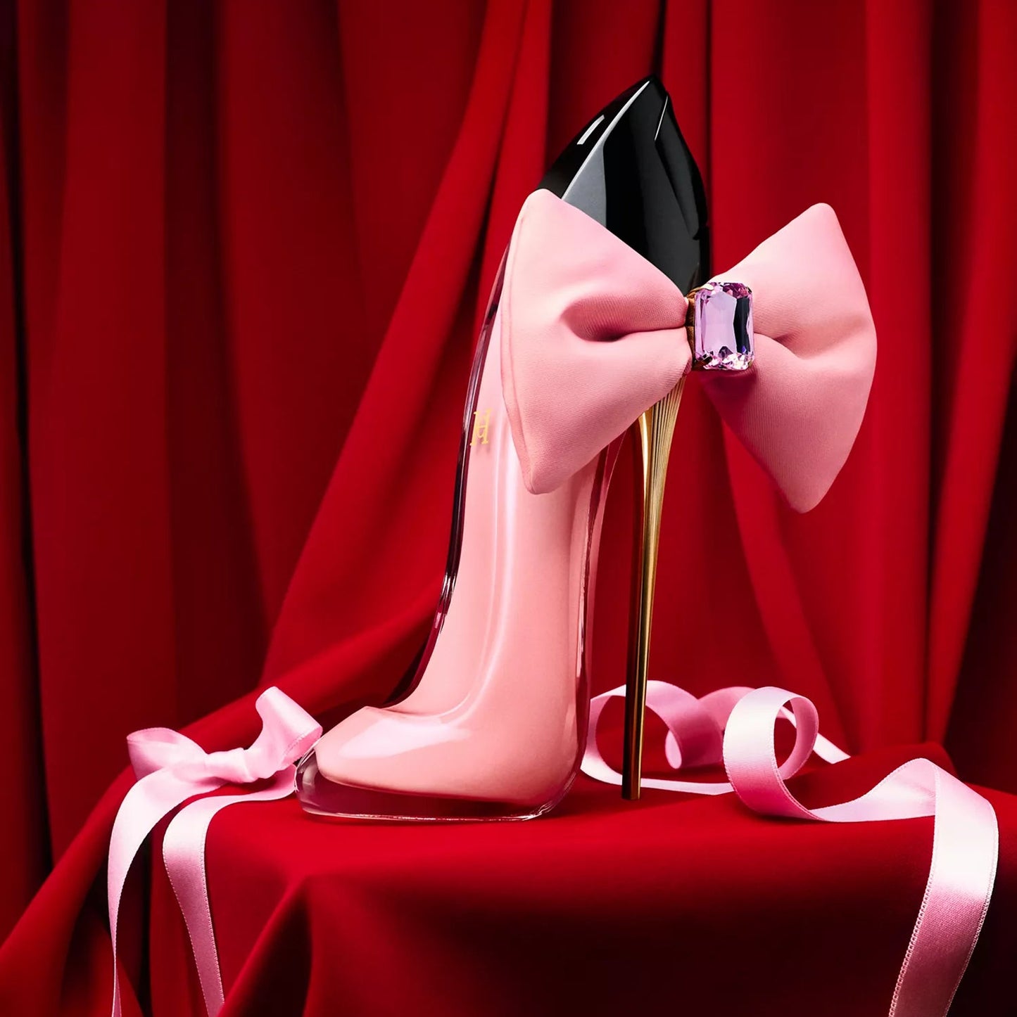 Pink high-heeled shoe with a large bow on a red background