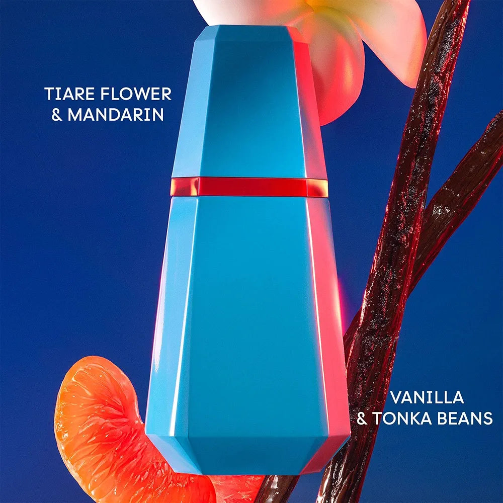 Blue perfume bottle with red accents on a blue background, surrounded by flowers and vanilla beans.