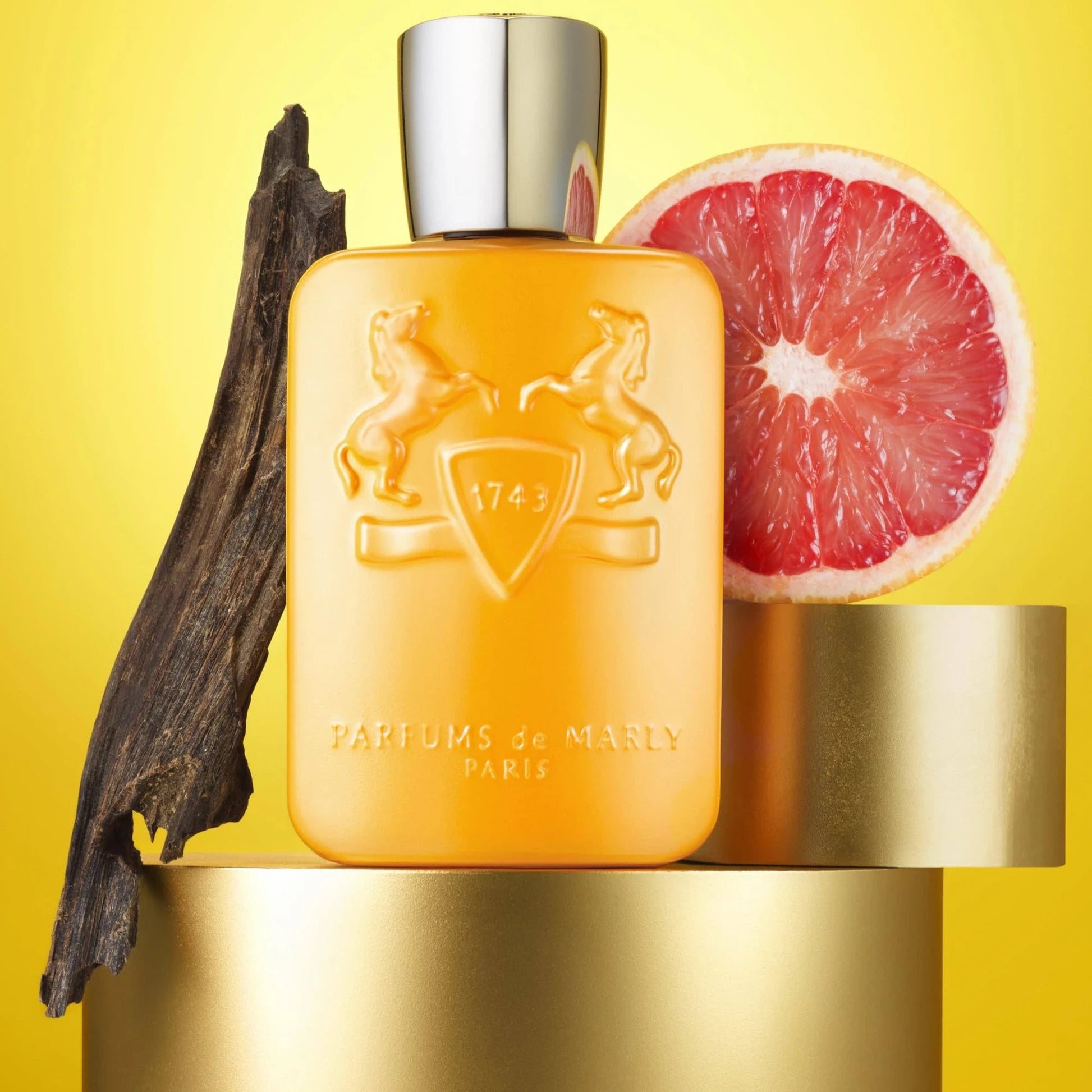 Perfume bottle with decorative elements on a yellow background