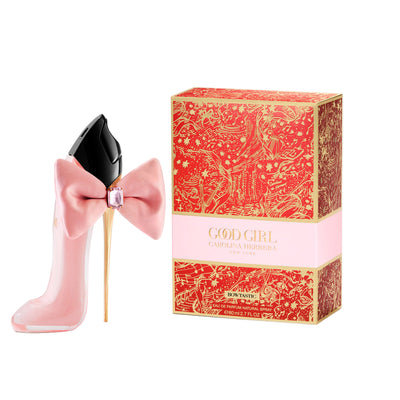 Pink perfume bottle with bow and decorative box on a white background