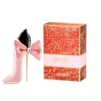 Pink perfume bottle with bow and decorative box on a white background