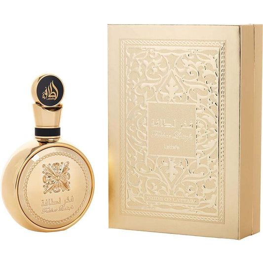 Gold perfume bottle and packaging with intricate designs on a white background