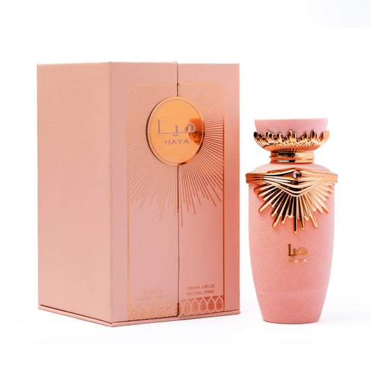 Pink and gold perfume bottle with packaging on a white background