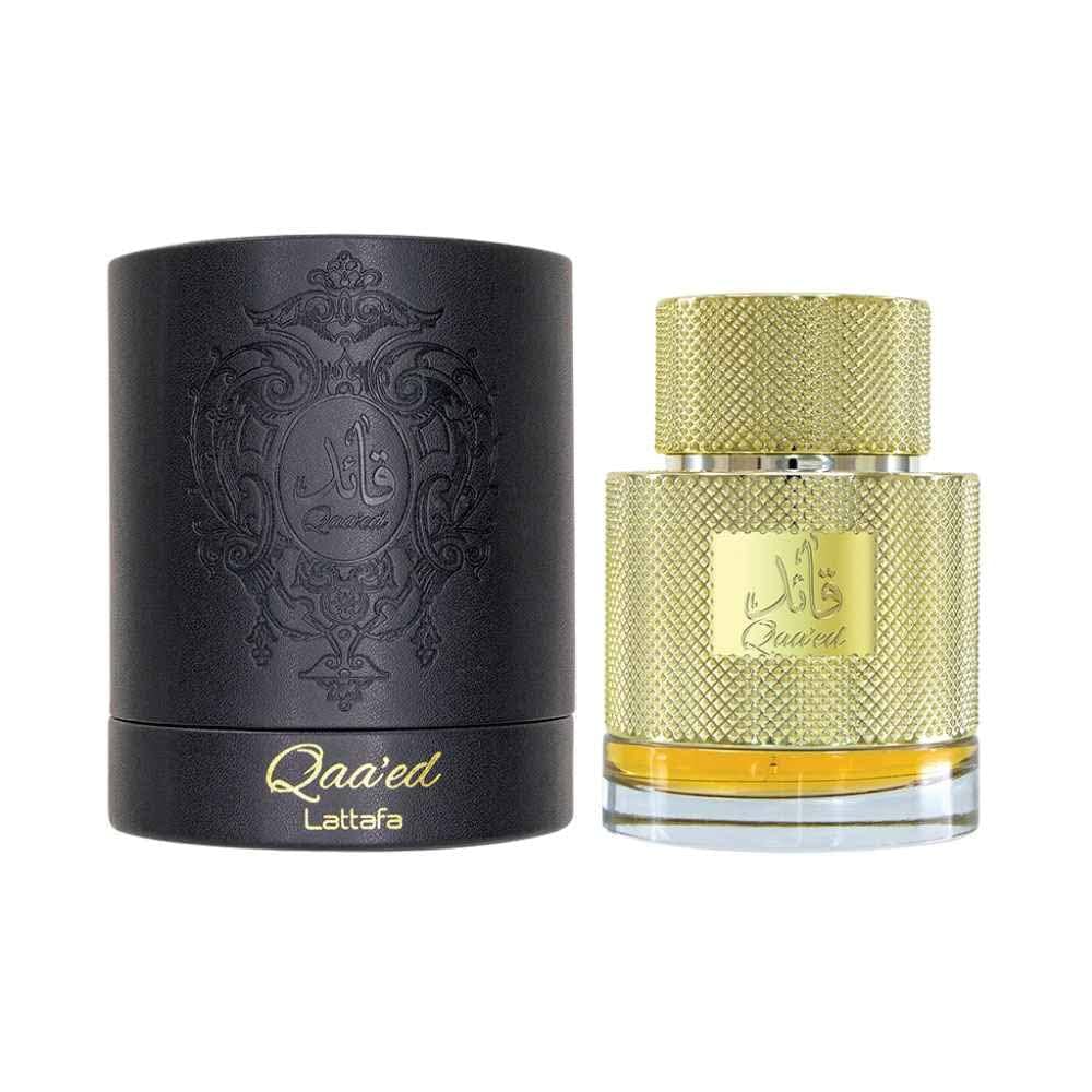 Black and gold perfume bottle with decorative design on a white background