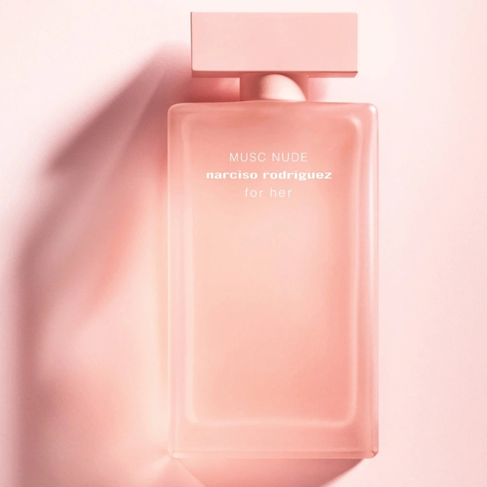 Pink perfume bottle labeled 'Musc Nude' by Narciso Rodriguez on a light pink background