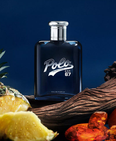 Polo Eau de Parfum bottle with vanilla beans, pineapple, and amber on a dark blue background