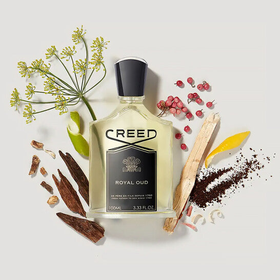 Creed Royal Oud perfume bottle surrounded by natural elements on a light background