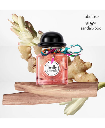 Perfume bottle with floral elements and 'Twilly d'Hermes' branding on a white background