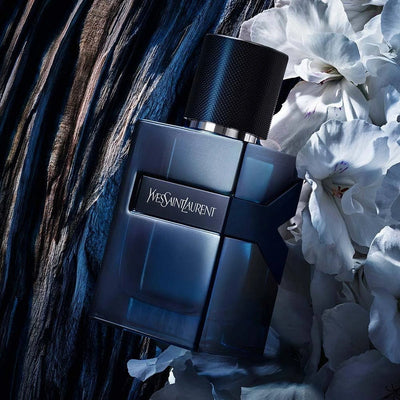 Yves Saint Laurent perfume bottle with white flowers in the background